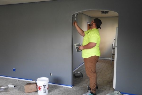 man painting home